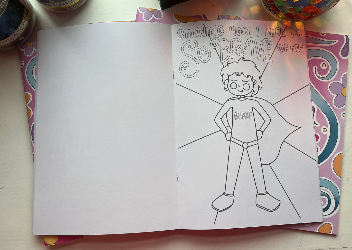 a page from daily dose of joy, it shows a superhero character and says 'showing how i feel is so brave of me'